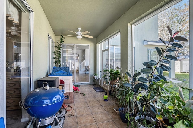 sunroom / solarium with ceiling fan and vaulted ceiling