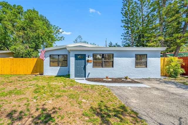 217 Emerald Ln, Largo, FL 33771 - view of front facade with stucco siding and fence