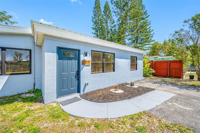 217 Emerald Ln, Largo, FL 33771 - property entrance featuring stucco siding and fence