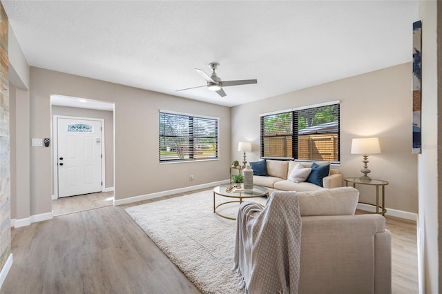 217 Emerald Ln, Largo, FL 33771 - living room with light wood-type flooring, baseboards, and ceiling fan