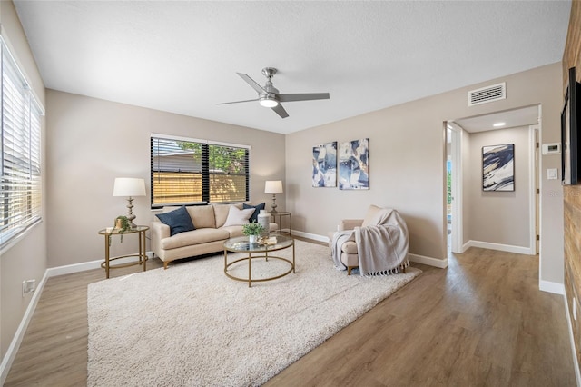 217 Emerald Ln, Largo, FL 33771 - living room with wood finished floors, baseboards, ceiling fan, and visible vents