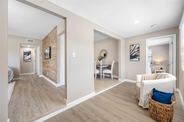 217 Emerald Ln, Largo, FL 33771 - corridor featuring baseboards, light wood-style floors, an accent wall, and visible vents