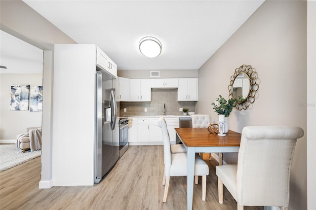 217 Emerald Ln, Largo, FL 33771 - dining room with light wood-type flooring, baseboards, and visible vents