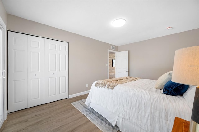 217 Emerald Ln, Largo, FL 33771 - bedroom featuring baseboards, visible vents, a closet, and light wood-style flooring