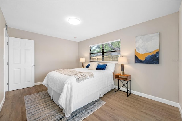217 Emerald Ln, Largo, FL 33771 - bedroom featuring baseboards, visible vents, and wood finished floors