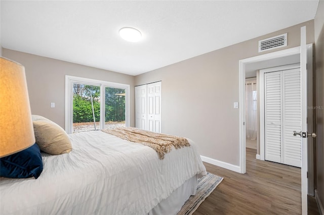 217 Emerald Ln, Largo, FL 33771 - bedroom featuring baseboards, access to outside, visible vents, a closet, and wood finished floors