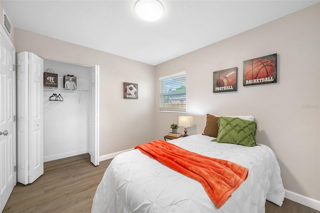 217 Emerald Ln, Largo, FL 33771 - bedroom with baseboards, a closet, and wood finished floors
