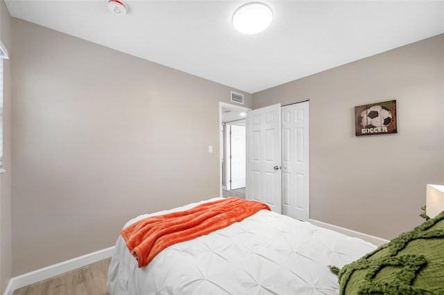 217 Emerald Ln, Largo, FL 33771 - bedroom with wood finished floors, a closet, baseboards, and visible vents