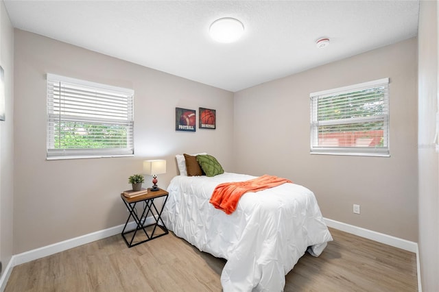 217 Emerald Ln, Largo, FL 33771 - bedroom featuring baseboards and wood finished floors