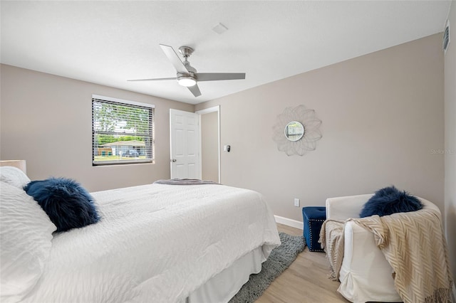 217 Emerald Ln, Largo, FL 33771 - bedroom with baseboards, ceiling fan, and light wood-type flooring