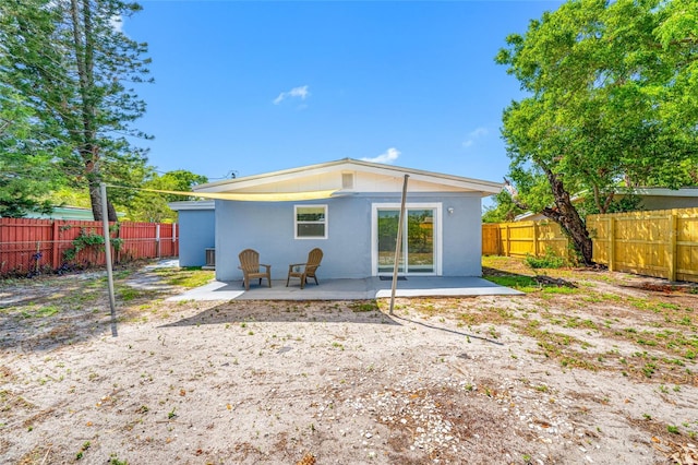 217 Emerald Ln, Largo, FL 33771 - back of house with a patio, a fenced backyard, and stucco siding