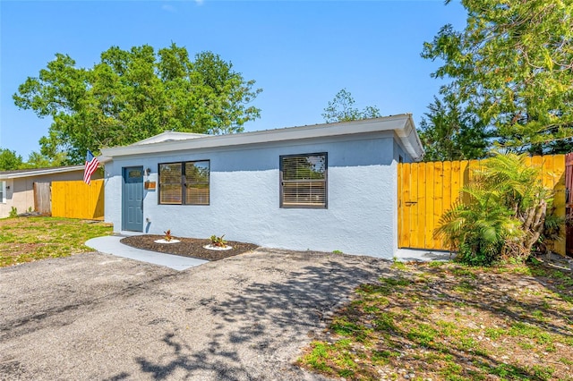 217 Emerald Ln, Largo, FL 33771 - view of front of house featuring stucco siding and fence