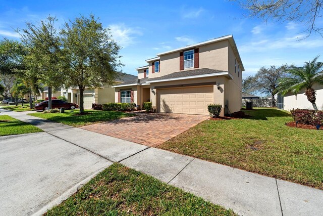 754 Andalusia Loop, Davenport, FL 33837 - traditional home featuring stucco siding, decorative driveway, an attached garage, and roof with shingles