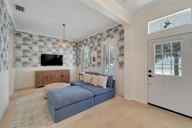 foyer featuring visible vents, a wainscoted wall, wallpapered walls, tile patterned flooring, and crown molding