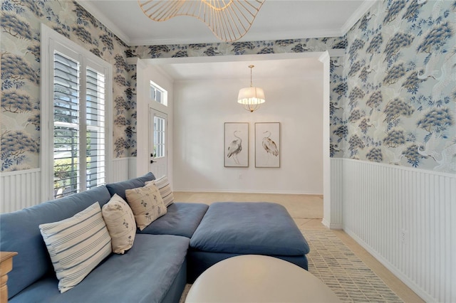 living room with wainscoting, wallpapered walls, and crown molding