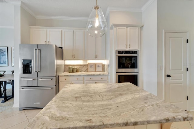 kitchen featuring white cabinetry, ornamental molding, and stainless steel appliances