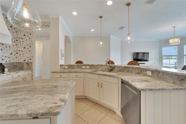 kitchen featuring light stone counters, arched walkways, ornamental molding, a sink, and dishwasher