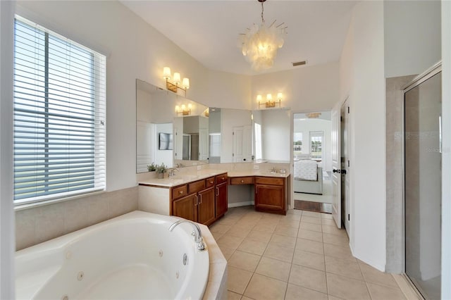 bathroom with vanity, a shower stall, tile patterned flooring, a chandelier, and a whirlpool tub