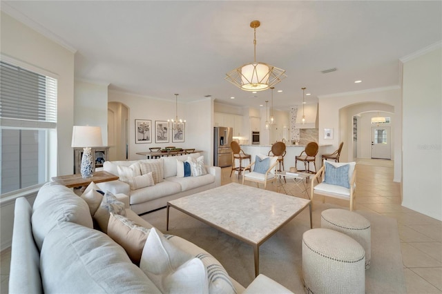 living room with arched walkways, light tile patterned floors, recessed lighting, and ornamental molding