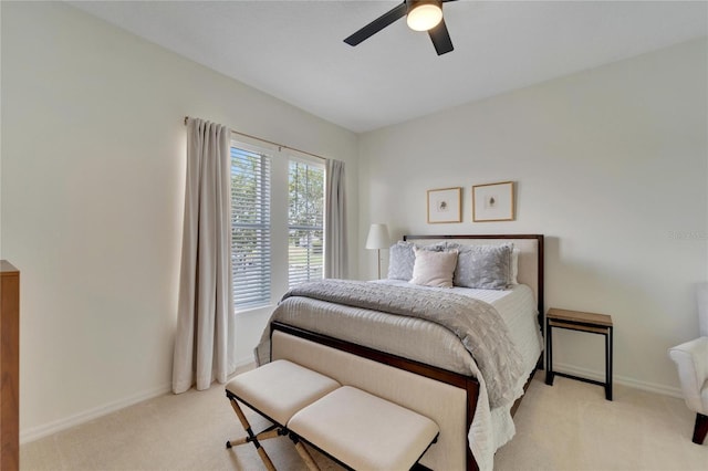 bedroom featuring baseboards, ceiling fan, and carpet flooring