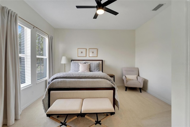 bedroom with visible vents, carpet floors, baseboards, and a ceiling fan