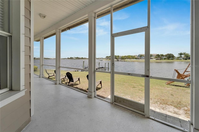 unfurnished sunroom with a water view