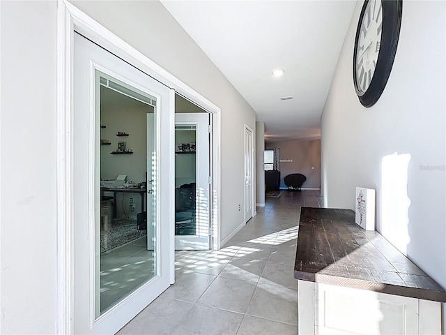 hall with light tile patterned floors