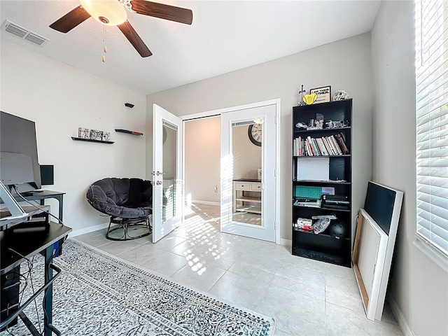 office area featuring baseboards, visible vents, ceiling fan, tile patterned flooring, and french doors