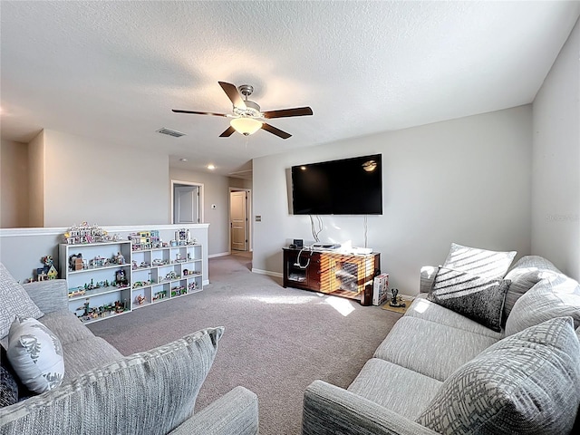 carpeted living room featuring visible vents, baseboards, a textured ceiling, and a ceiling fan