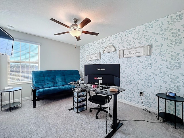 office featuring wallpapered walls, baseboards, carpet, a textured ceiling, and a ceiling fan