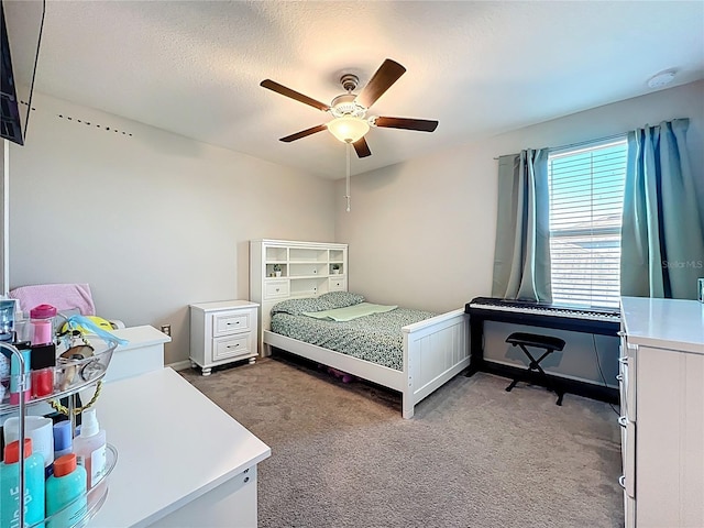 bedroom with light colored carpet, a textured ceiling, and ceiling fan