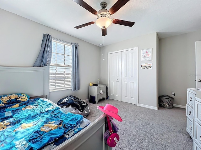 bedroom featuring a closet, carpet flooring, baseboards, and ceiling fan