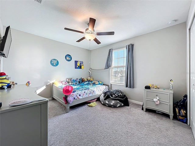 carpeted bedroom with baseboards, a textured ceiling, and ceiling fan