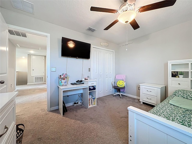 bedroom with light carpet, visible vents, and a textured ceiling