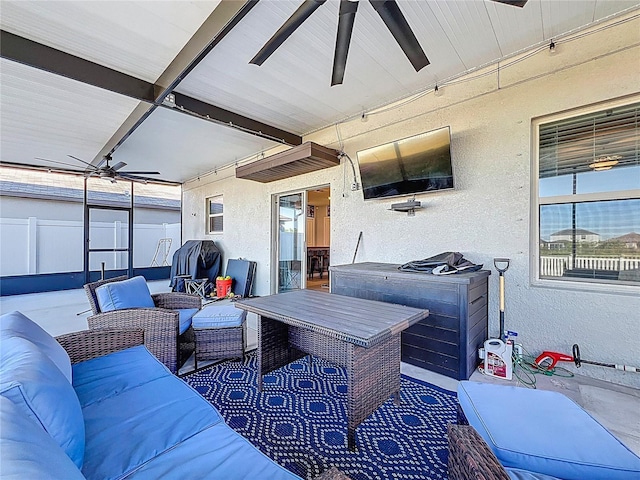 view of patio / terrace with an outdoor living space, fence, and ceiling fan