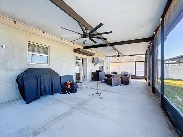 sunroom / solarium featuring a ceiling fan and a healthy amount of sunlight