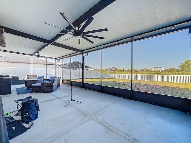 unfurnished sunroom featuring ceiling fan