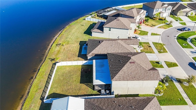 drone / aerial view with a residential view and a water view