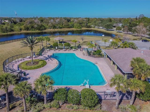 pool with a water view and fence