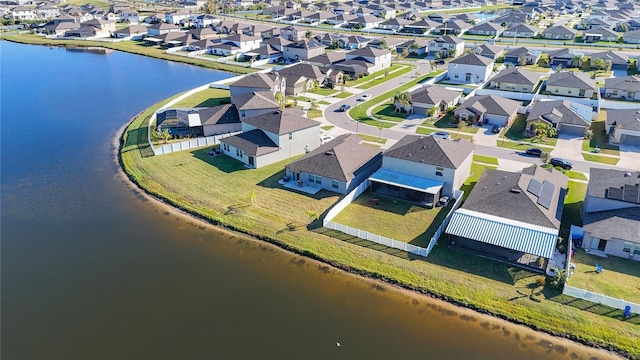 drone / aerial view featuring a residential view and a water view