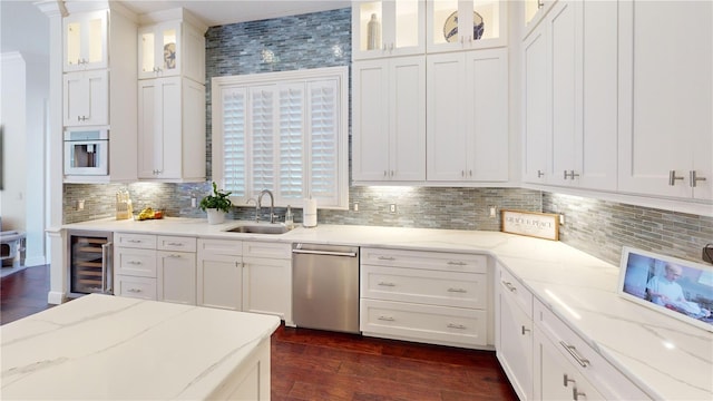 kitchen with beverage cooler, white cabinetry, a sink, dark wood-type flooring, and dishwasher