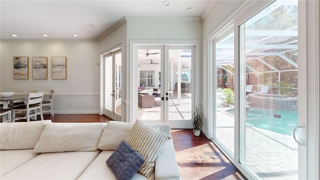 living room with baseboards, ornamental molding, recessed lighting, french doors, and wood finished floors