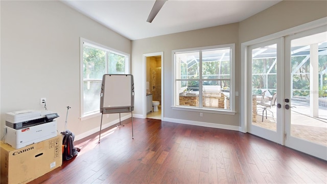 interior space with baseboards, dark wood-style floors, and a ceiling fan