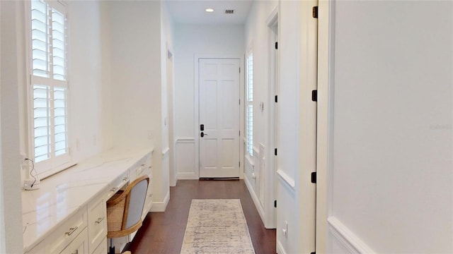 mudroom with dark wood-type flooring, recessed lighting, and visible vents