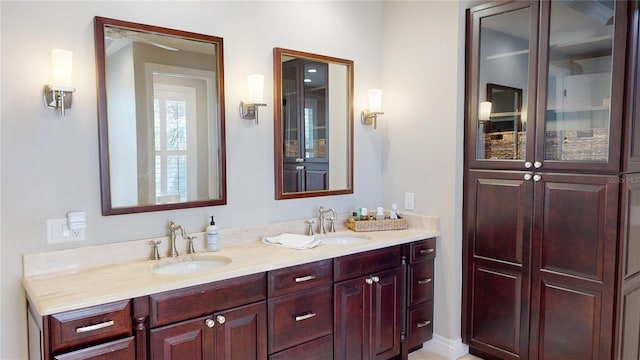 full bathroom with a sink and double vanity