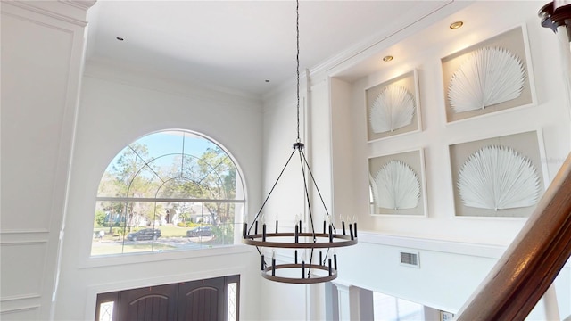 details featuring a chandelier, visible vents, and crown molding