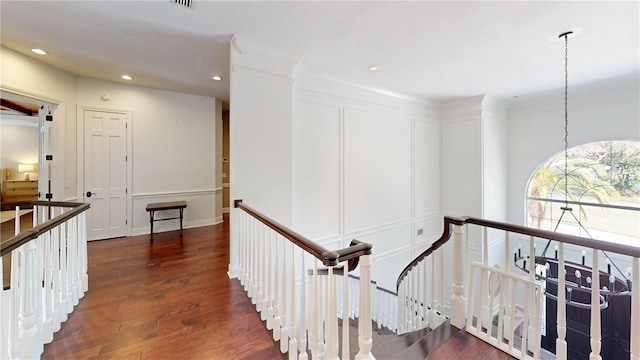 stairs with recessed lighting, wood finished floors, and visible vents