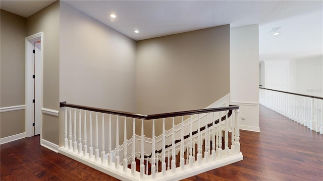 hallway featuring an upstairs landing, visible vents, recessed lighting, and wood finished floors