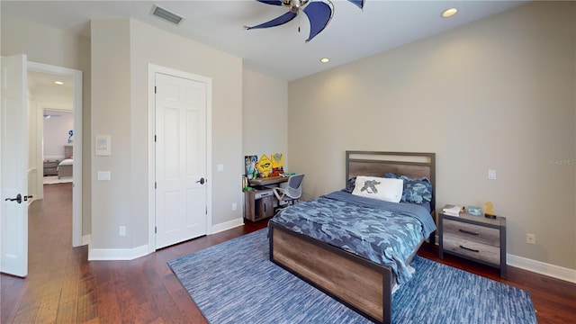 bedroom with visible vents, baseboards, and wood finished floors