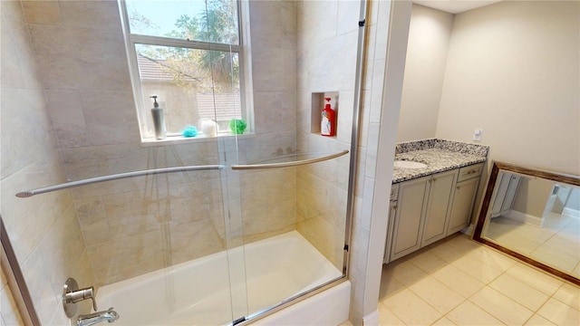 full bathroom featuring tile patterned flooring, plenty of natural light, vanity, and bath / shower combo with glass door